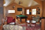 Clubhouse game room with pool table and foosball
